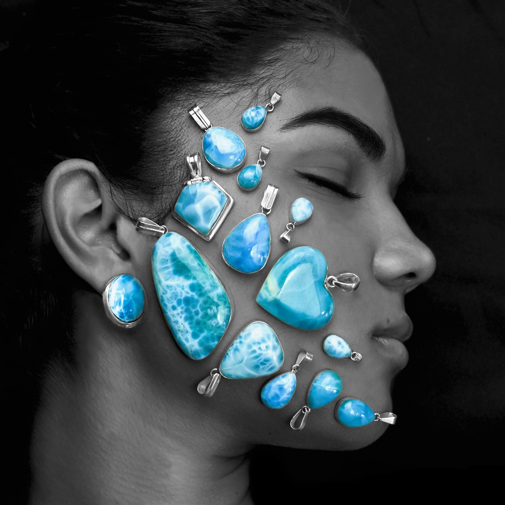 blue gems placed on a girl's face to show their beauty